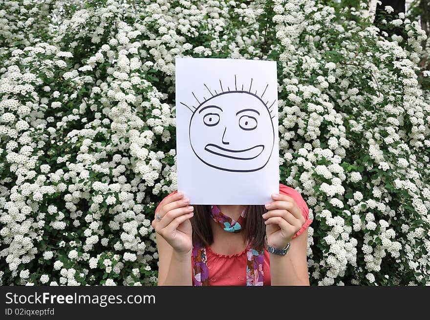 Beautiful girl with a sheet of paper over th