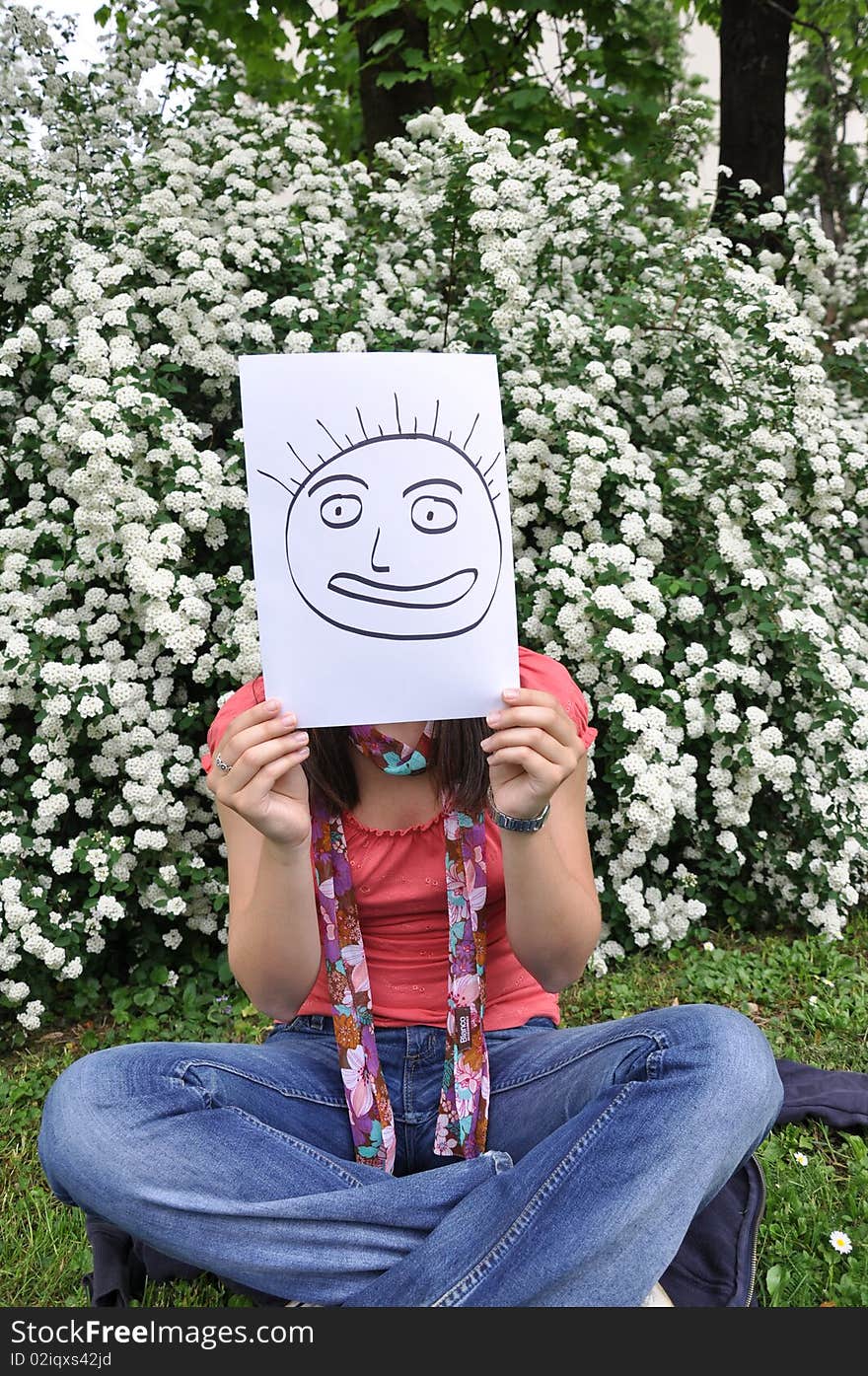 Beautiful young girl with a sheet of paper over the face. Beautiful young girl with a sheet of paper over the face