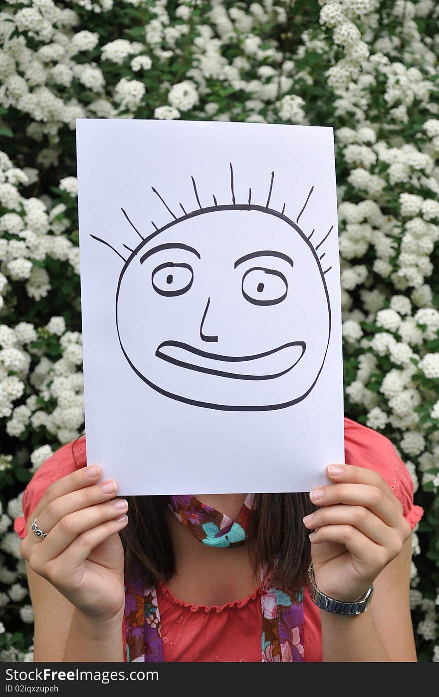 Beautiful young girl with a sheet of paper over the face. Beautiful young girl with a sheet of paper over the face