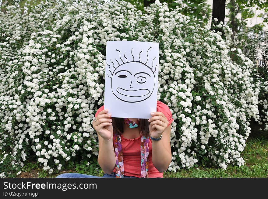 Beautiful young girl with a sheet of paper over the face. Beautiful young girl with a sheet of paper over the face