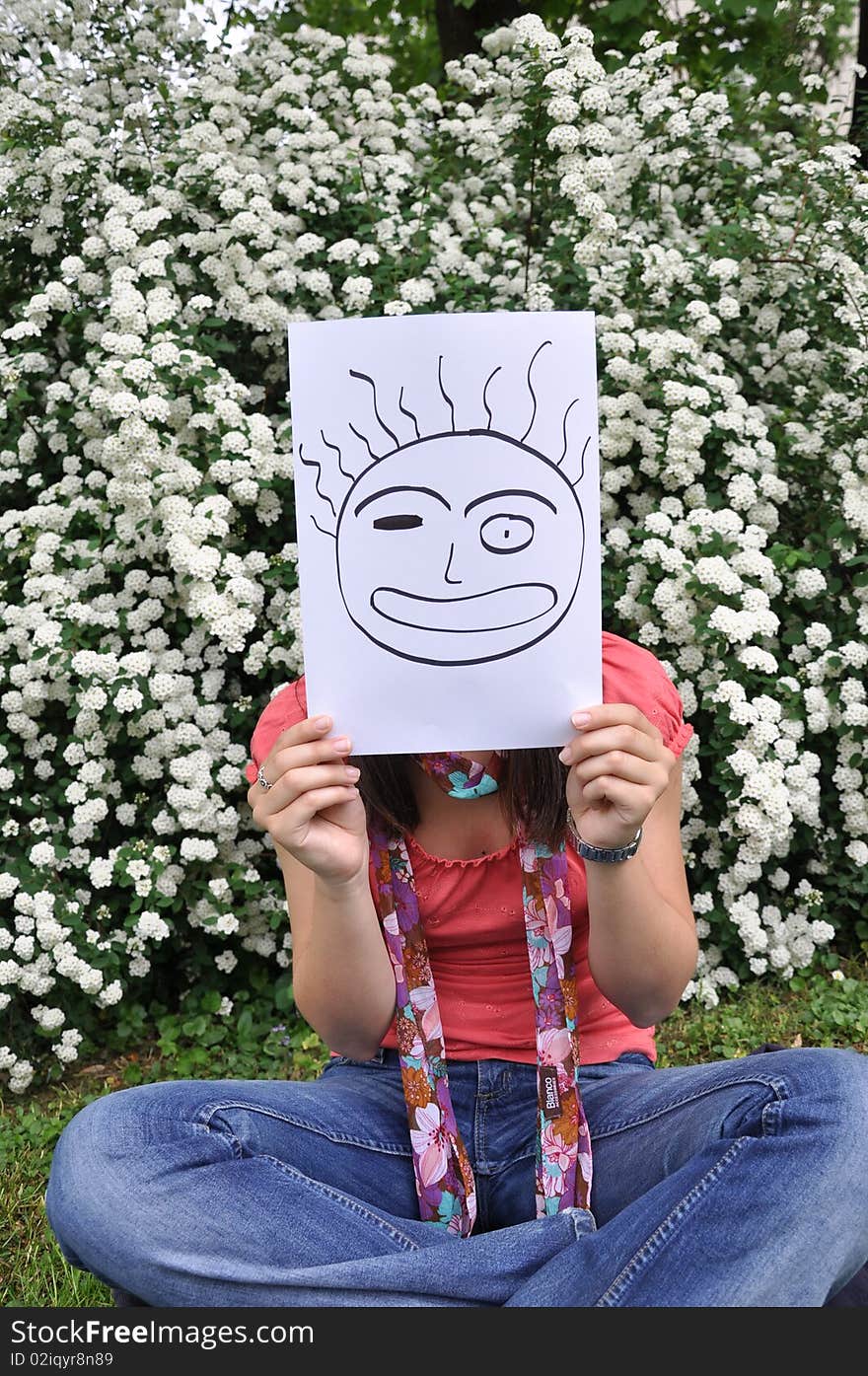 Beautiful young girl with a sheet of paper over the face. Beautiful young girl with a sheet of paper over the face