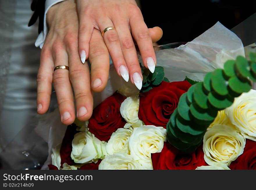 Bride and groom hands with rings and fowers bouquet. Bride and groom hands with rings and fowers bouquet