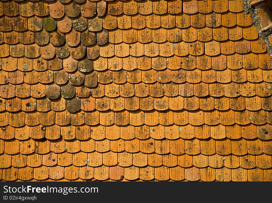 Uneven roof tiles marked by time. Uneven roof tiles marked by time