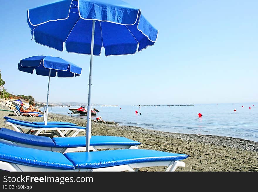 Deckchairs on the sandy beach.