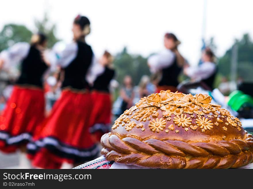 Festive loaf on a background of dancing people. Festive loaf on a background of dancing people