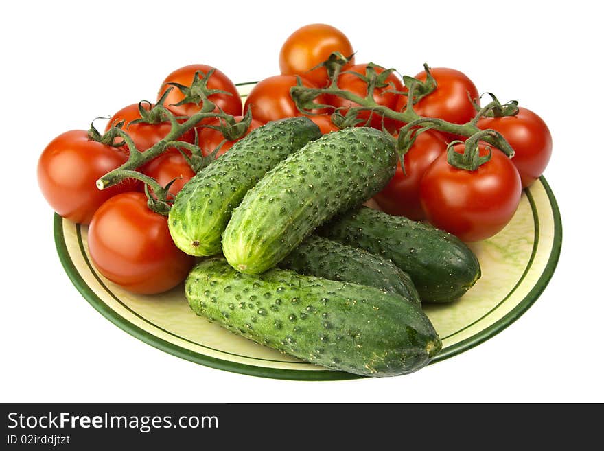 Fresh raw tomatoes and cucumbers on a plate. Fresh raw tomatoes and cucumbers on a plate