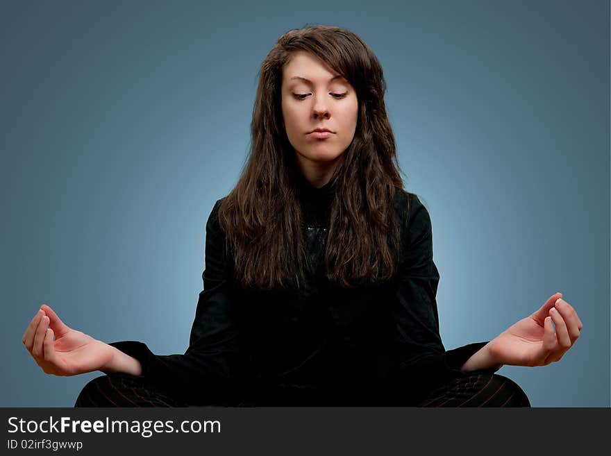 Attractive Girl In Dark Clothes Meditating