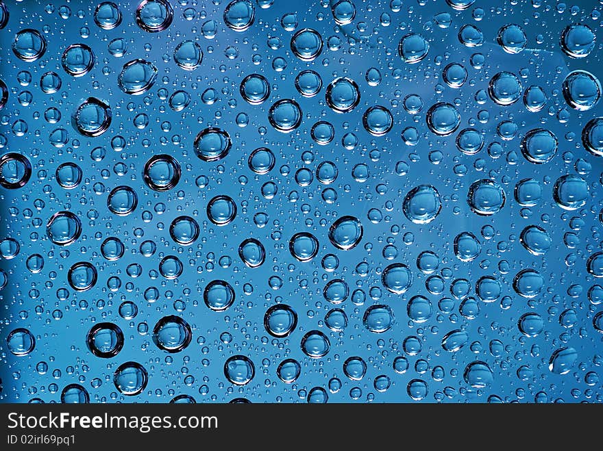 Close up of water drops in blue light