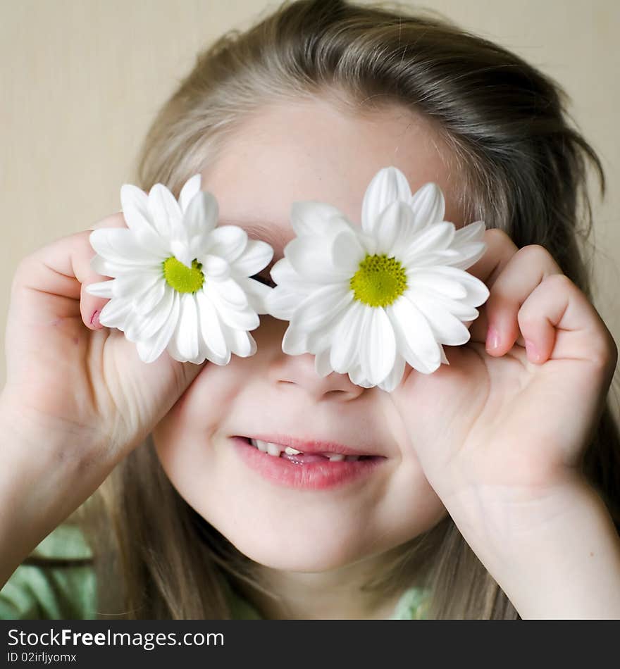 An image of a girl with chamomiles on her eyes. An image of a girl with chamomiles on her eyes