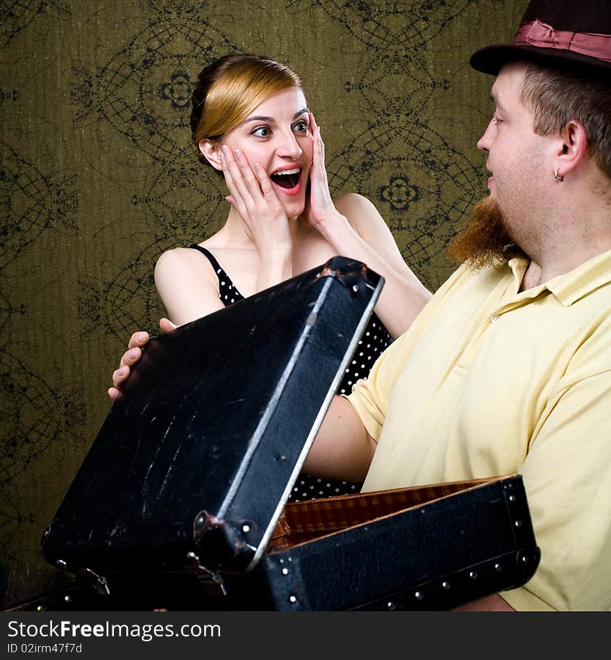 An image of a woman and a man with a valise. An image of a woman and a man with a valise