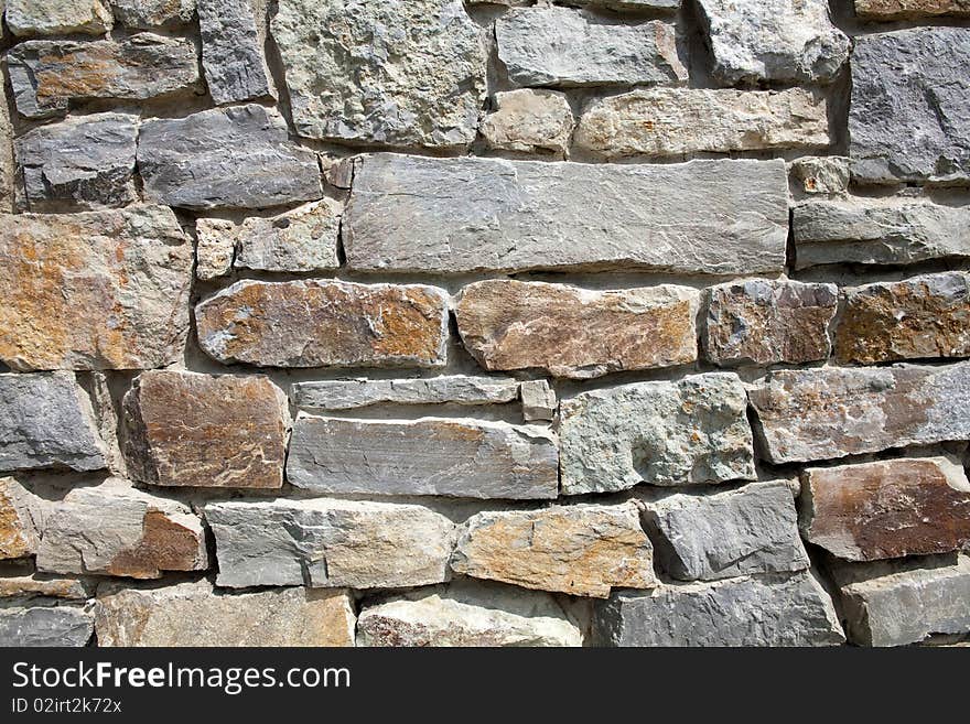 An image of a grey wall of stone