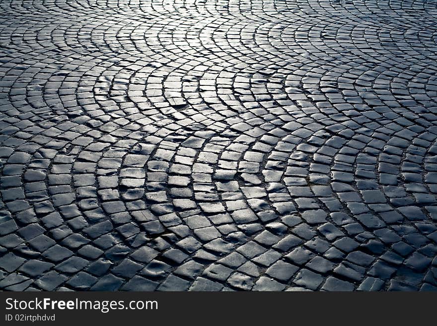 An image of a beautiful old road of grey stones