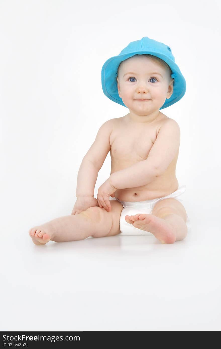 Merry child in blue hat on white background. Merry child in blue hat on white background.