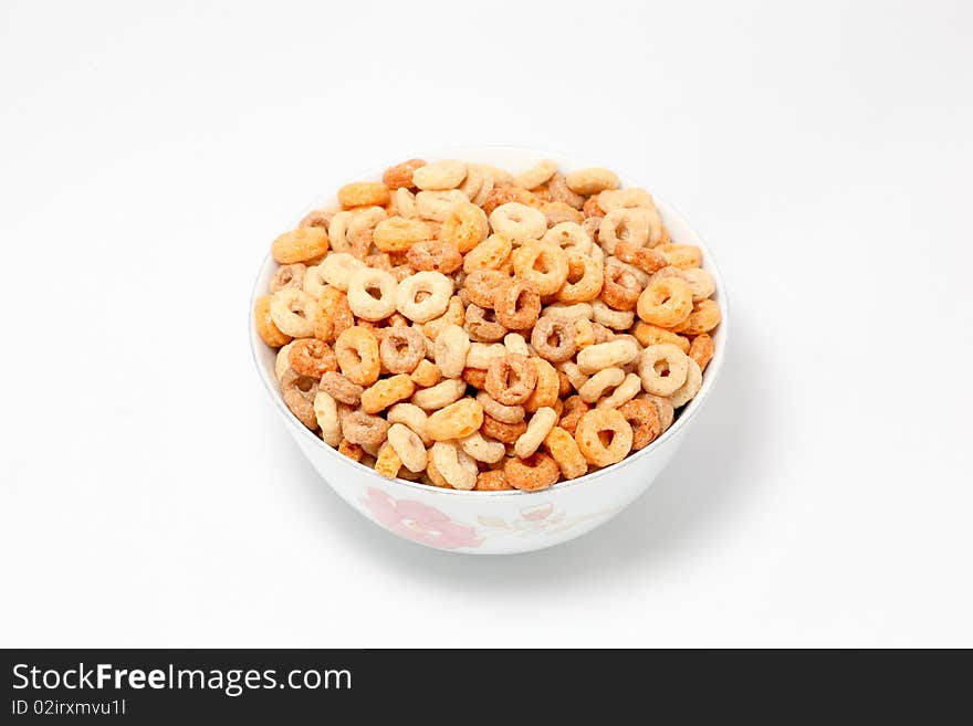 Bowl full of Oat Hoops on white background