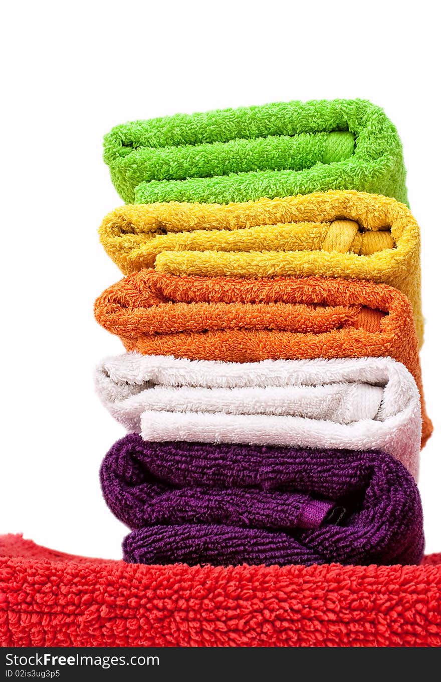 Stacked colorful towels isolated on a white background. Stacked colorful towels isolated on a white background.