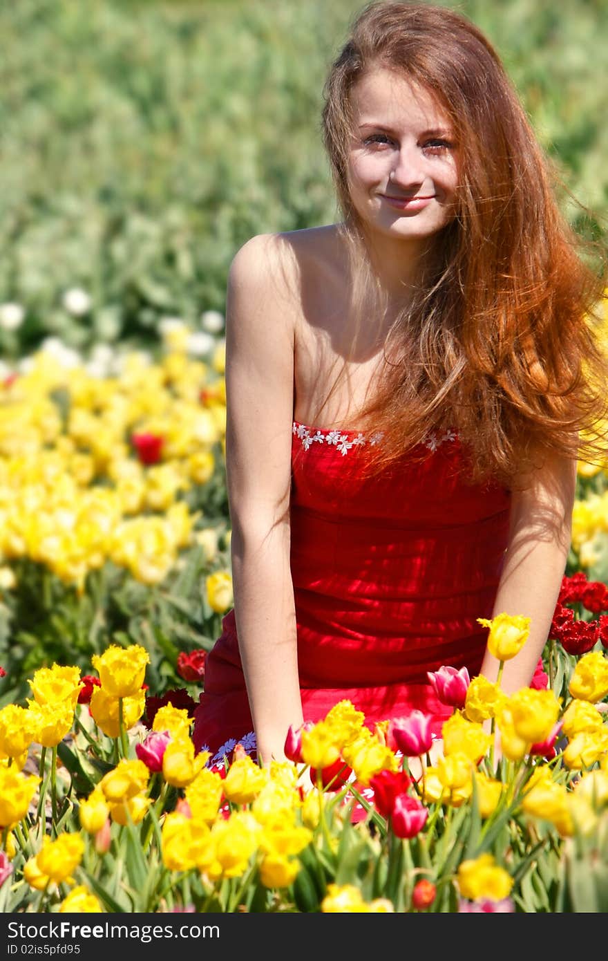 Young beautiful woman in yellow tulips