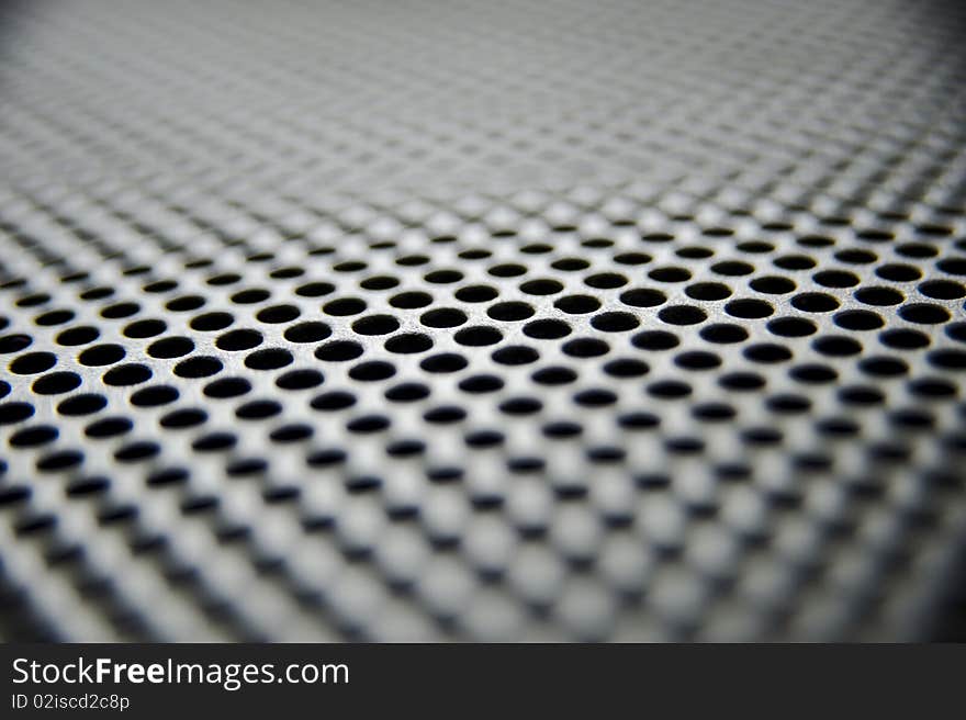 Metal sheet with holes taken as closeup. Metal sheet with holes taken as closeup