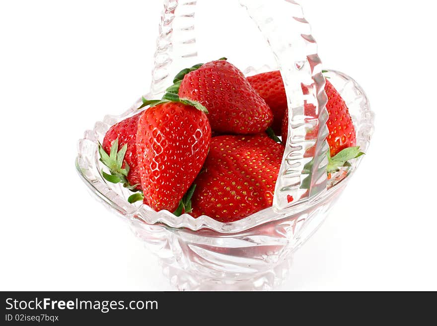 Strawberries in a glass basket isolated on white. Strawberries in a glass basket isolated on white