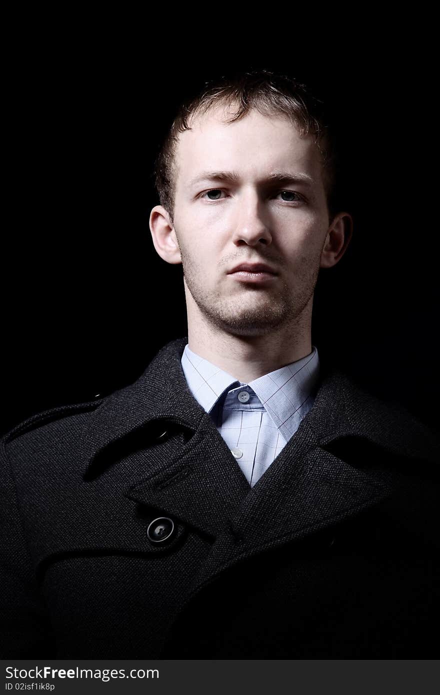 Portrait of man in blue shirt on black background. Portrait of man in blue shirt on black background