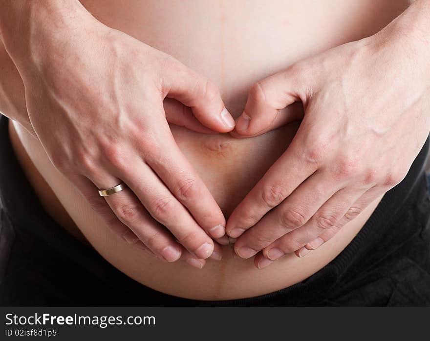 Advanced pregnant belly with hands