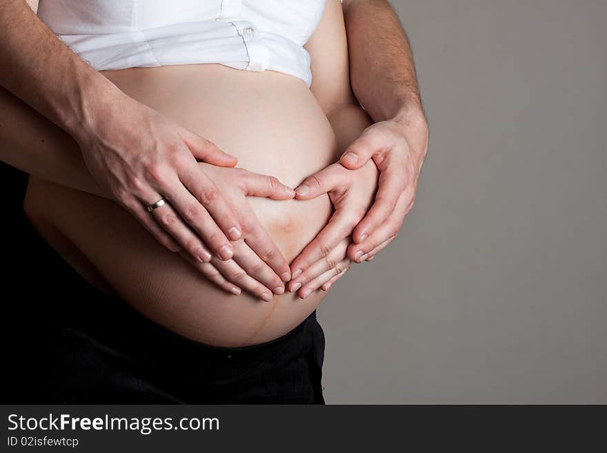 Pregnant belly with hands