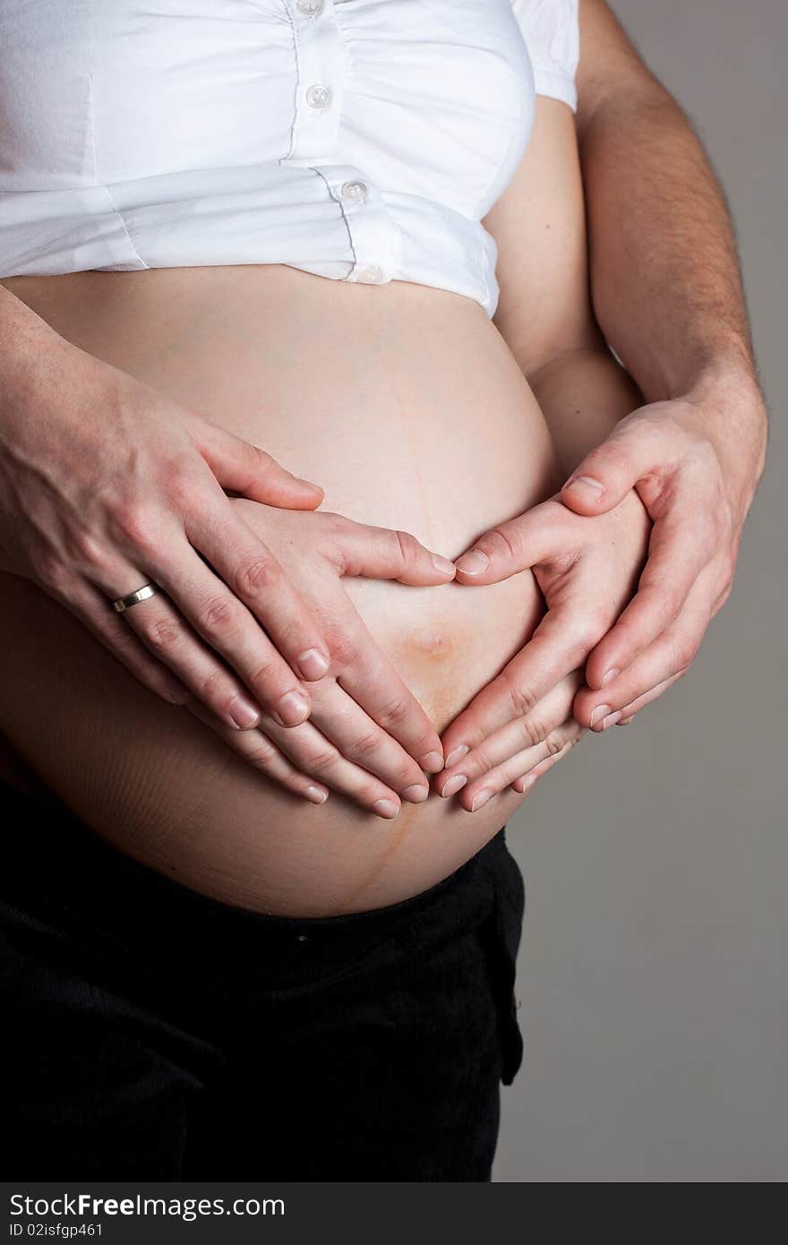 Advanced pregnant belly with hands