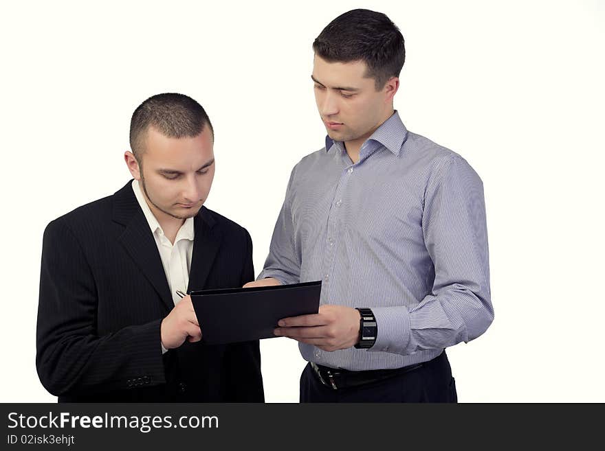 Two business people signing documents. Two business people signing documents