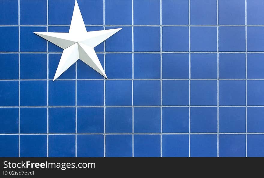 Simple white star against a blue tiled background. Simple white star against a blue tiled background