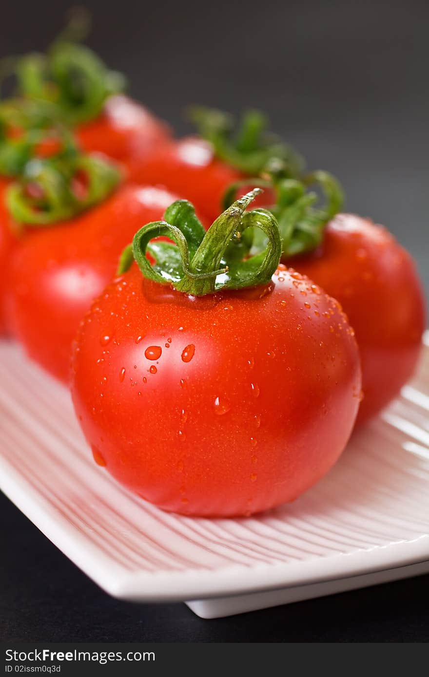 Ripe Red Tomatoes On A White Plate. Ripe Red Tomatoes On A White Plate