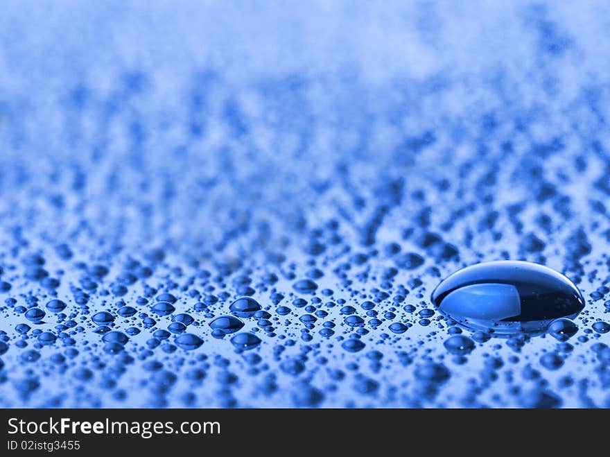 Macro photo of water drops on blue background