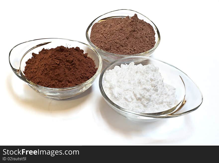 Cocoa cake and cocoa powder on a white background. Cocoa cake and cocoa powder on a white background