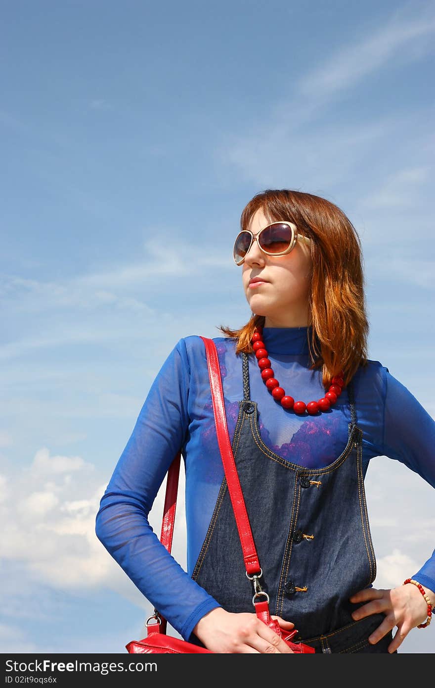 Pretty girl on the blue sky background