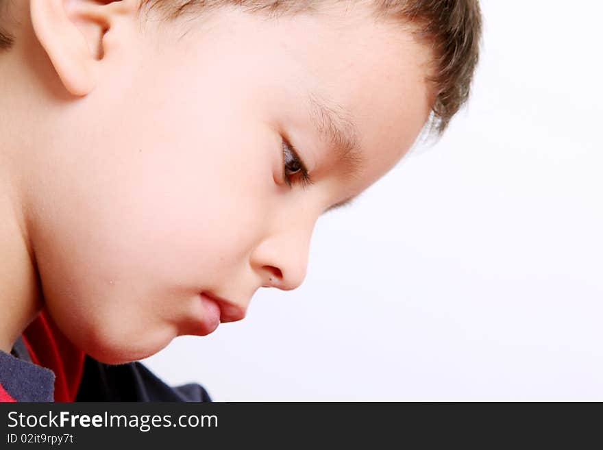 Close up of child writing and looking. Close up of child writing and looking