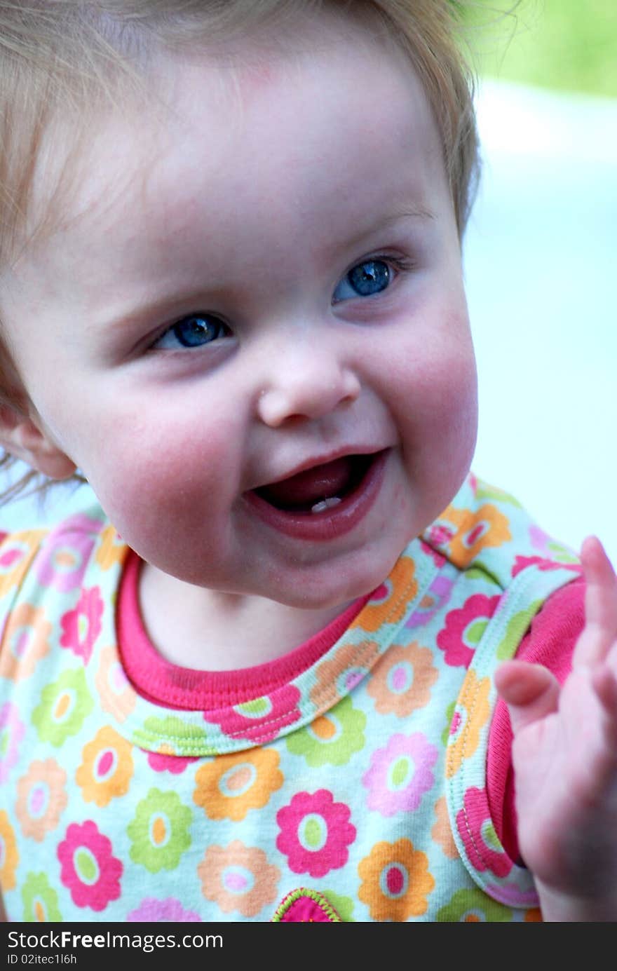 This is a photo of a baby girl smiling.