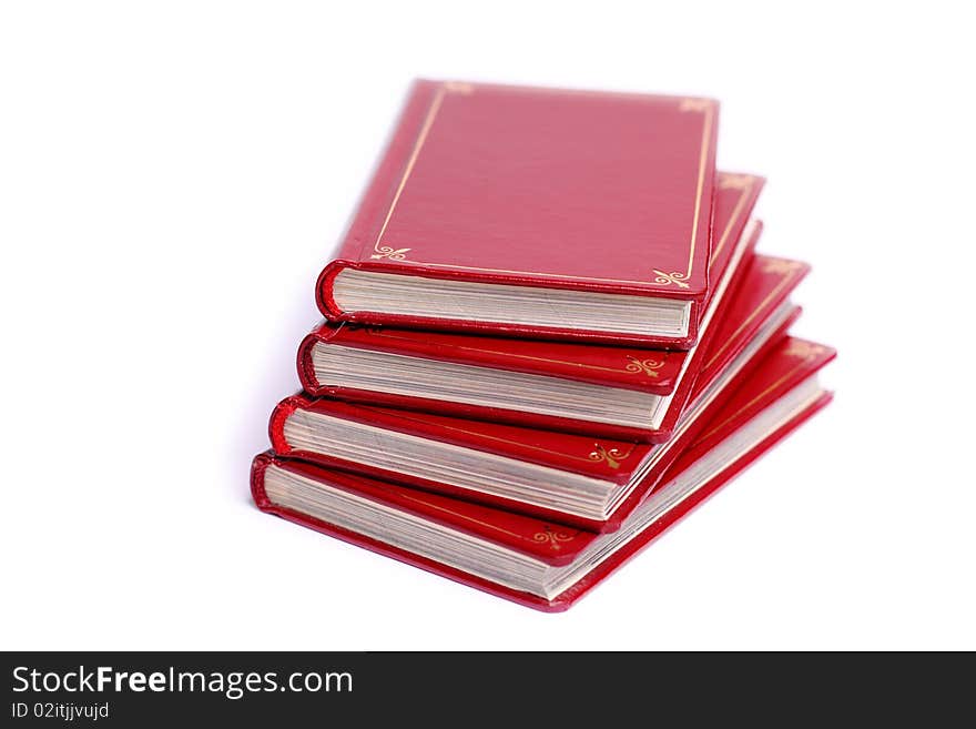 Four red books stacked up against white background. Four red books stacked up against white background