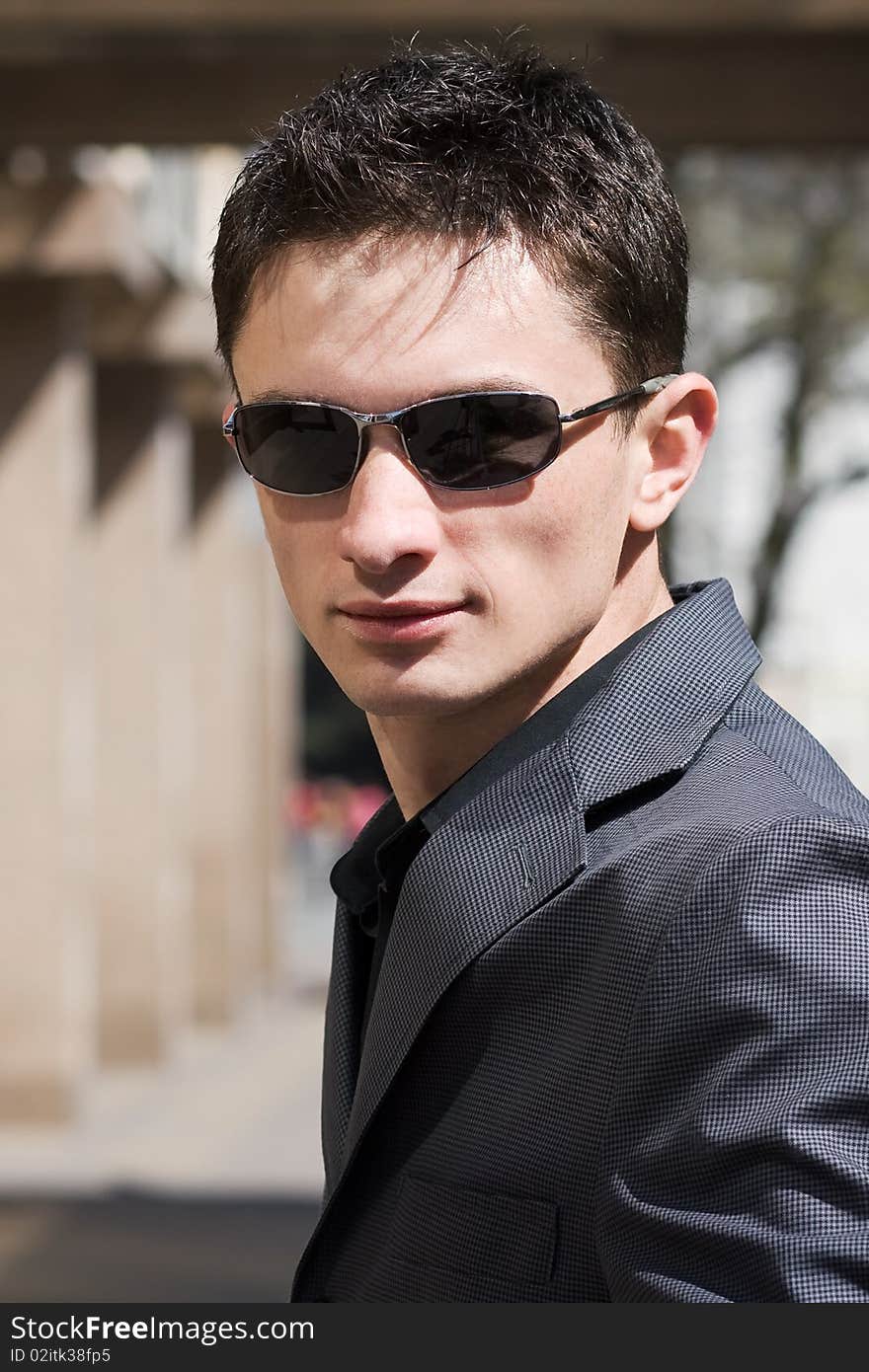 Portrait of young businessman in sunglasses