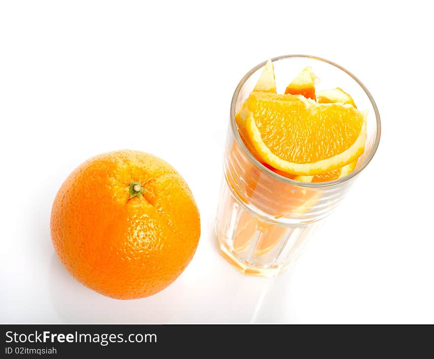 Orange and slices in glass isolated on white background