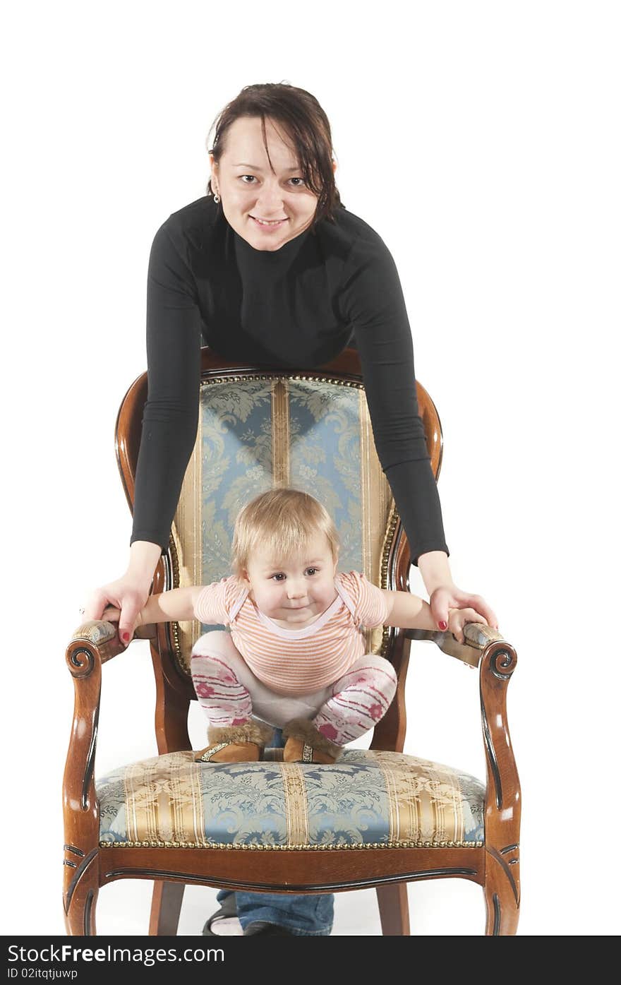 Young mother and daughter are sitting on chair. Isolated over white background. Young mother and daughter are sitting on chair. Isolated over white background