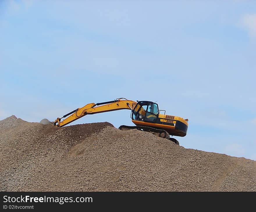 Yellow Excavator working on a mountain of rubble. Yellow Excavator working on a mountain of rubble