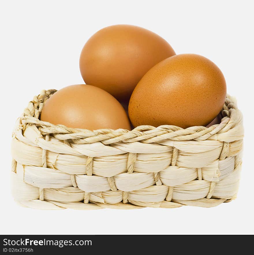 Eggs lie in basket on white background