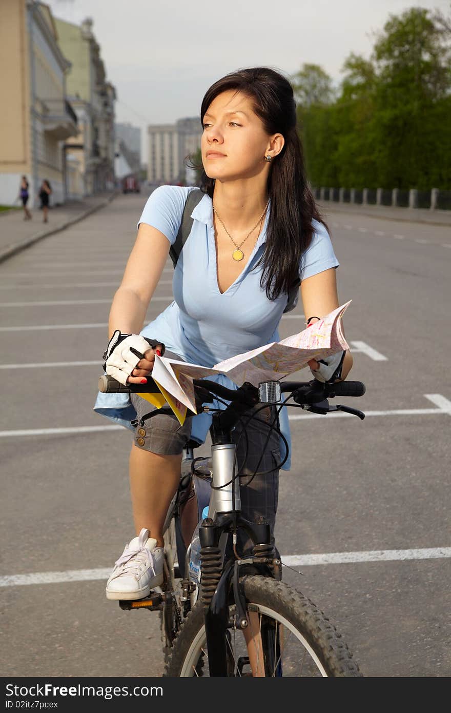 Female biker with the city map