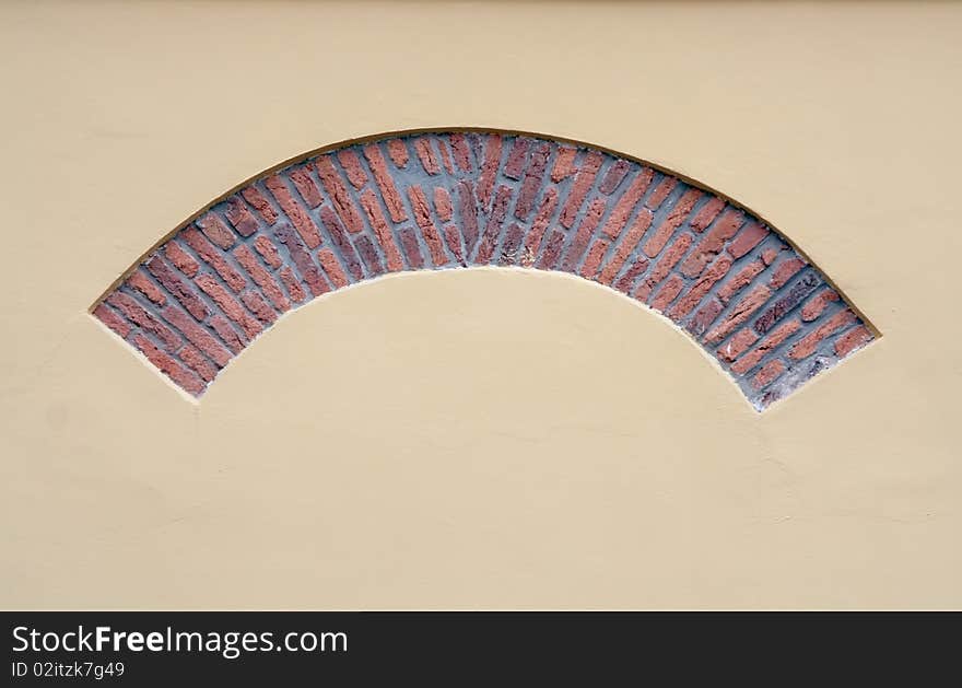 Brick arch in a yellow plastered wall. Brick arch in a yellow plastered wall.