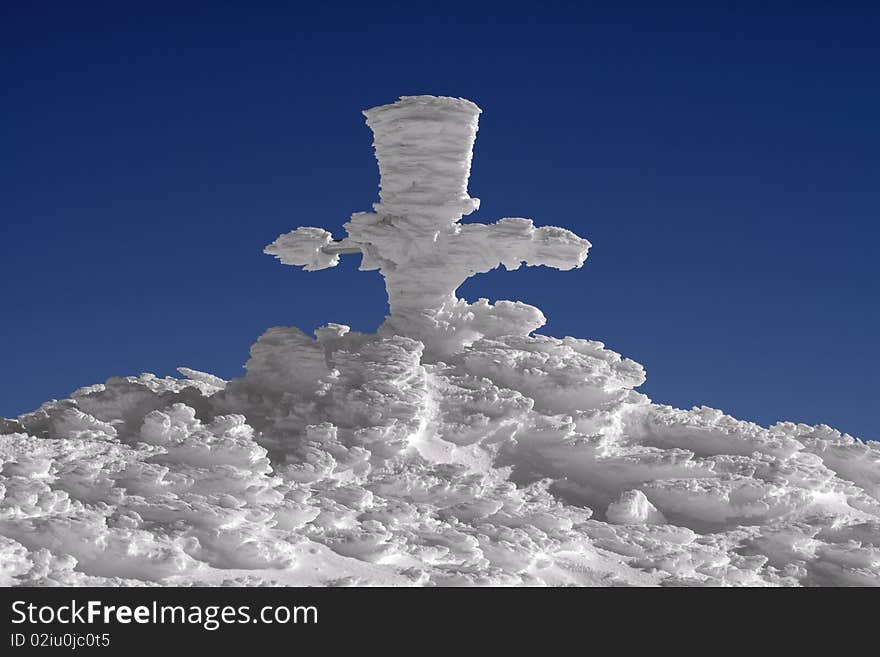 Gore's cross at Omu Peak 2500m , Bucegi Mountains, Carpathians, Romania, covered with hoar-frost. Gore's cross at Omu Peak 2500m , Bucegi Mountains, Carpathians, Romania, covered with hoar-frost.