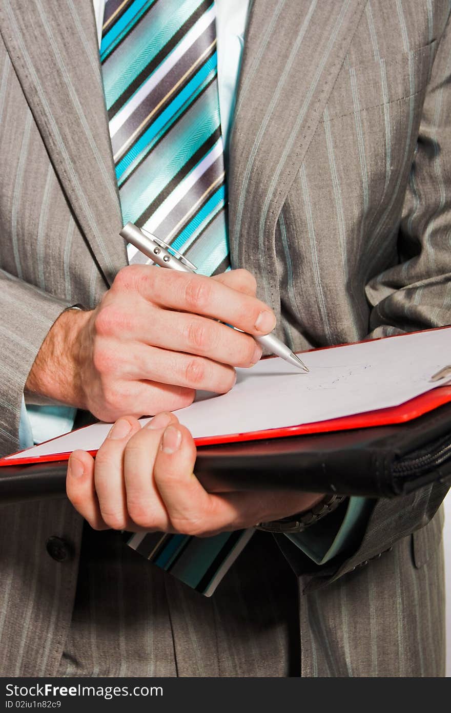 Businessman writes some document on white paper. Businessman writes some document on white paper