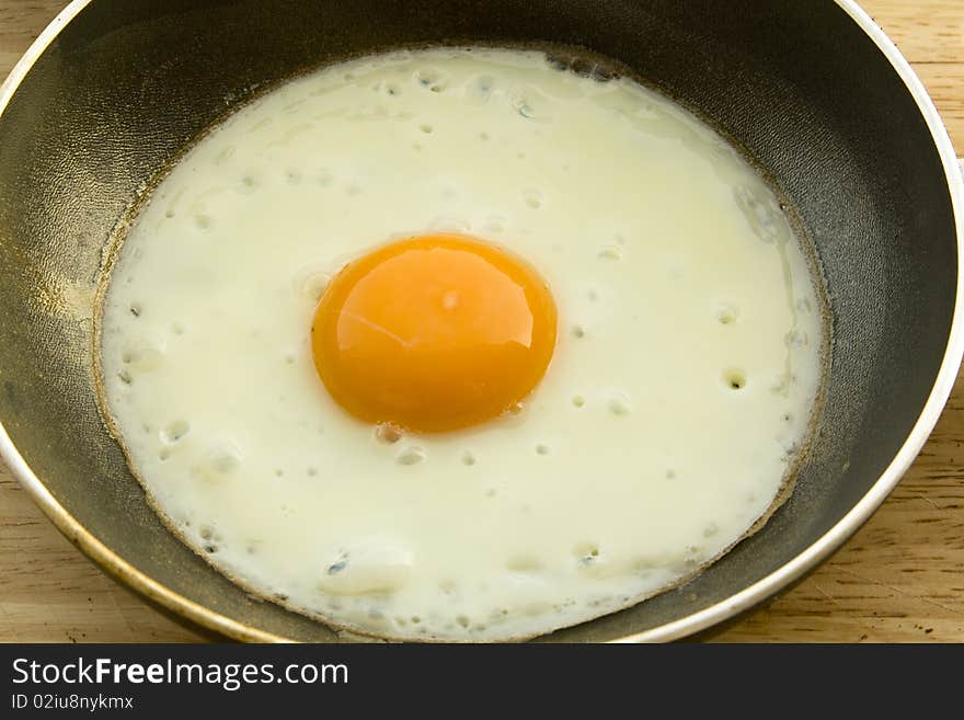 One fryed egg on steel pan