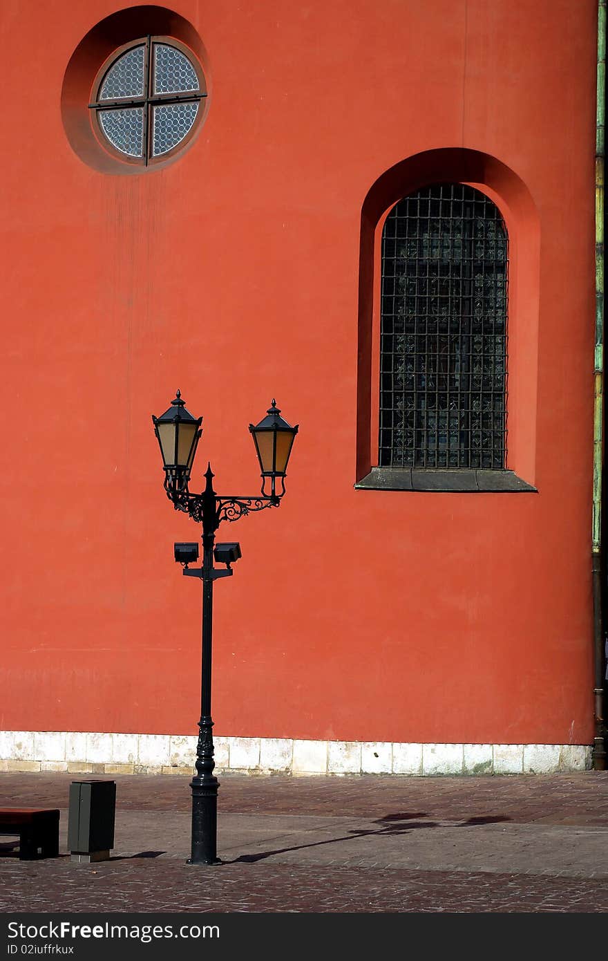 Street lamp on deep red wall