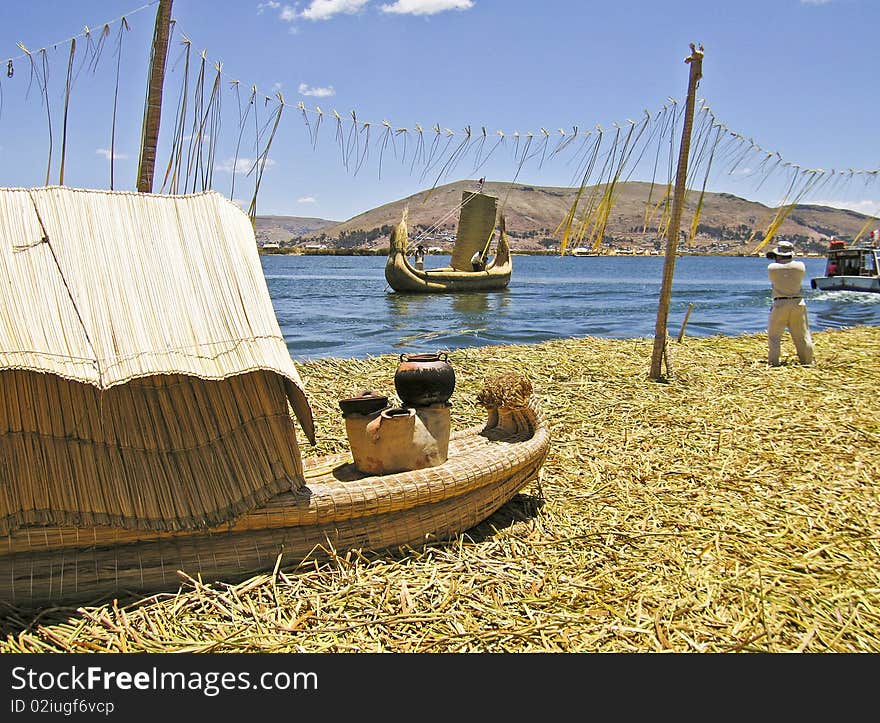 Floating reed island and boats on Lake Titicaca, Peru