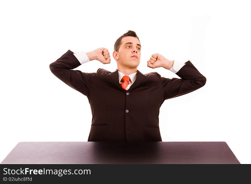 Tired businessman at his desk in the office, on white background