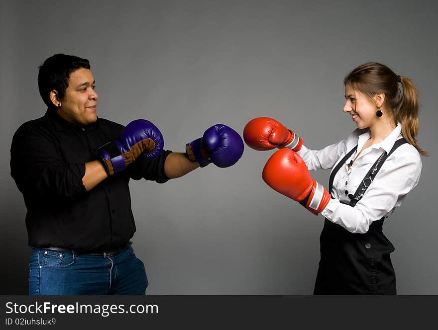 Girl and guy boxing in red and blue gloves. Girl and guy boxing in red and blue gloves