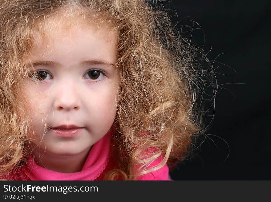 Beautiful young girl with curly hair and cute features. Beautiful young girl with curly hair and cute features